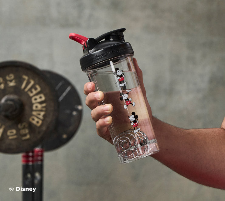 pro-series-g7 Mickey_Mouse_Protein_Shaker_Bottle_Being_Held_In_the_Gym.jpg